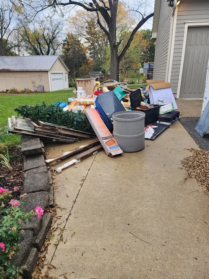 Dumpster being loaded with debris for 12 Yard Dumpster Rental in Gaithersburg